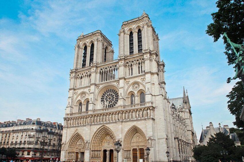 Notre-Dame Cathedral with two towers, a rose window, and Gothic architecture. 3