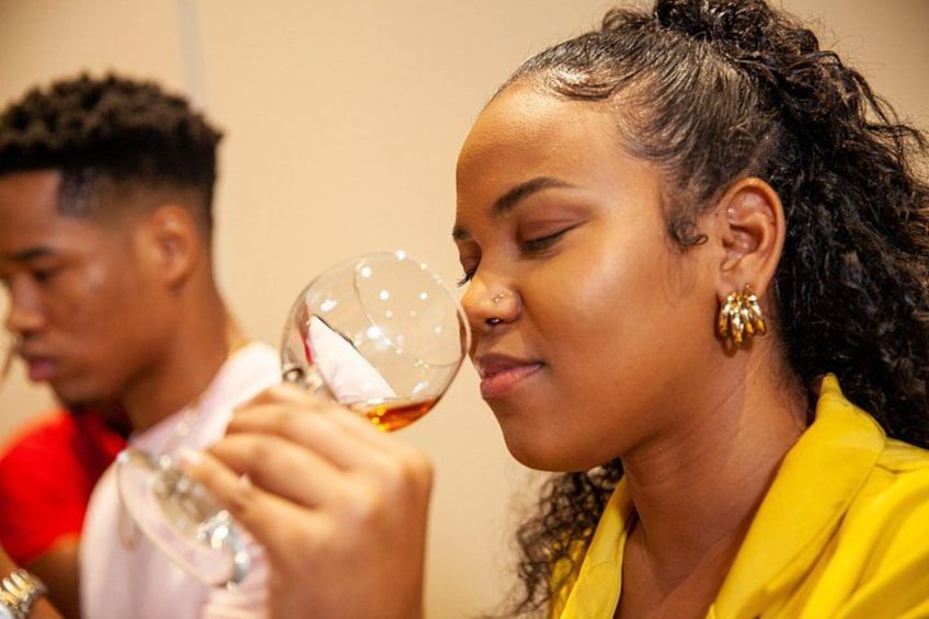 A person holding a wine glass. 1