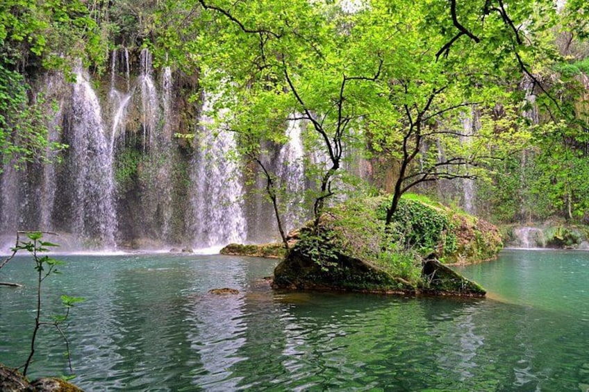 A waterfall, a calm river, and lush greenery. 4