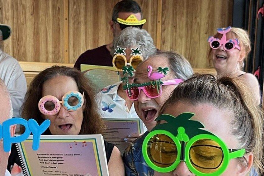 People wearing colorful sunglasses and holding a menu. 1
