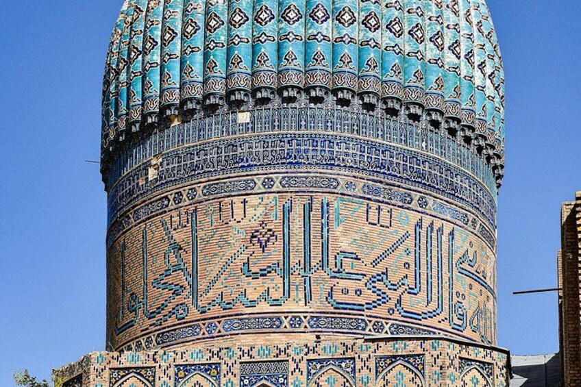 A mosque with intricate tile work and Arabic calligraphy. 3