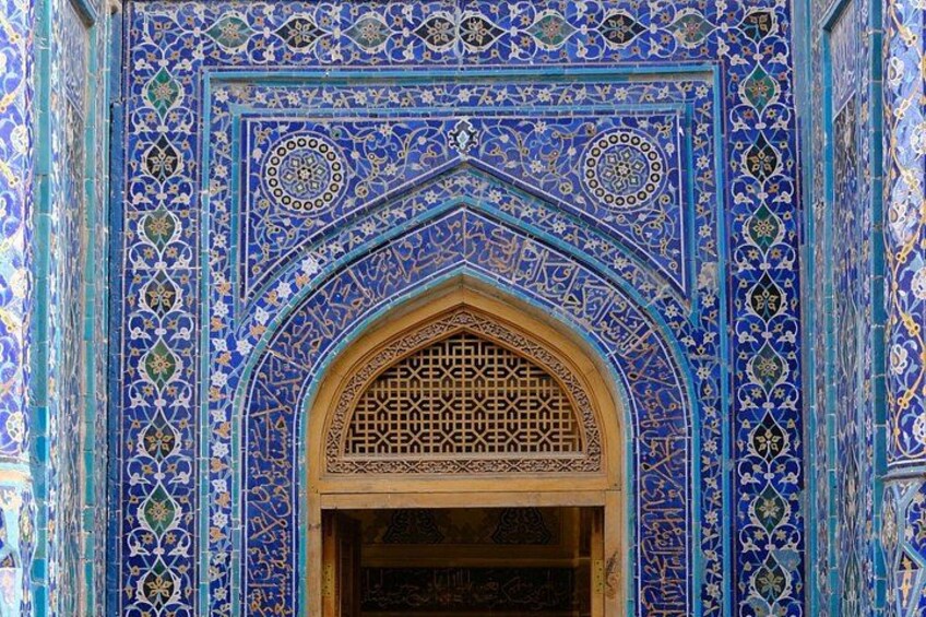 A detailed blue and gold patterned archway with intricate designs and calligraphy. 2