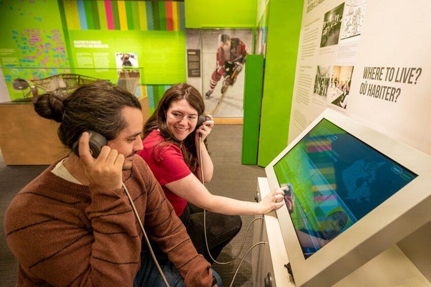 Two people using a touchscreen display in a museum. 2