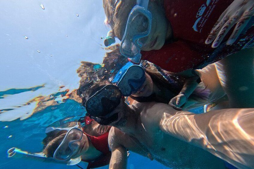 A group of people snorkeling underwater. 3