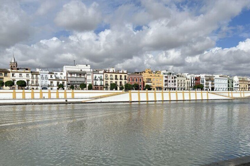 A waterfront with buildings and a bridge. 3