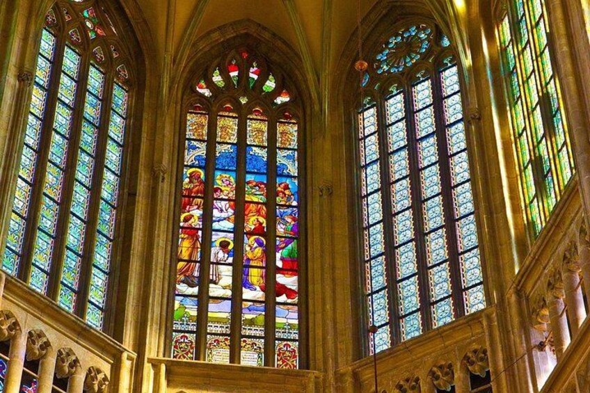 A cathedral interior with stained glass windows and Gothic architecture. 5