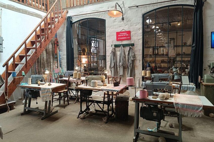 A workshop with tables, chairs, and sewing machines. 2