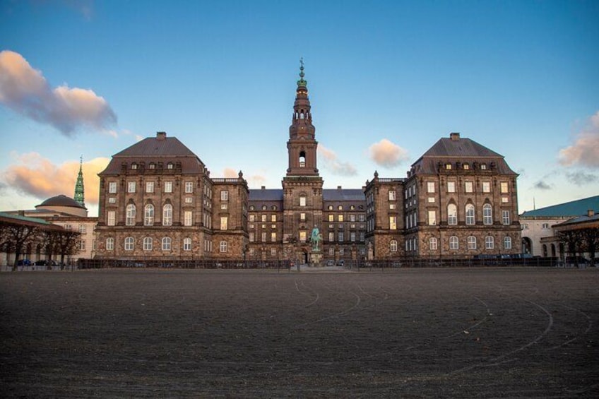 A large historic building with a central tower and two symmetrical wings. 2