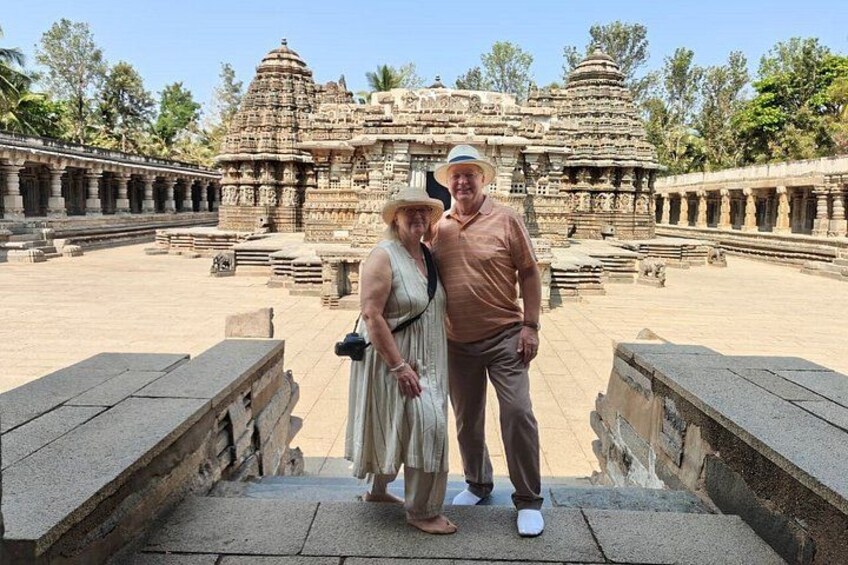 An ancient temple complex with intricate stone carvings and a large central structure. 4