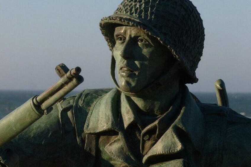 A statue of a soldier with a rifle, wearing a helmet and a jacket. 2