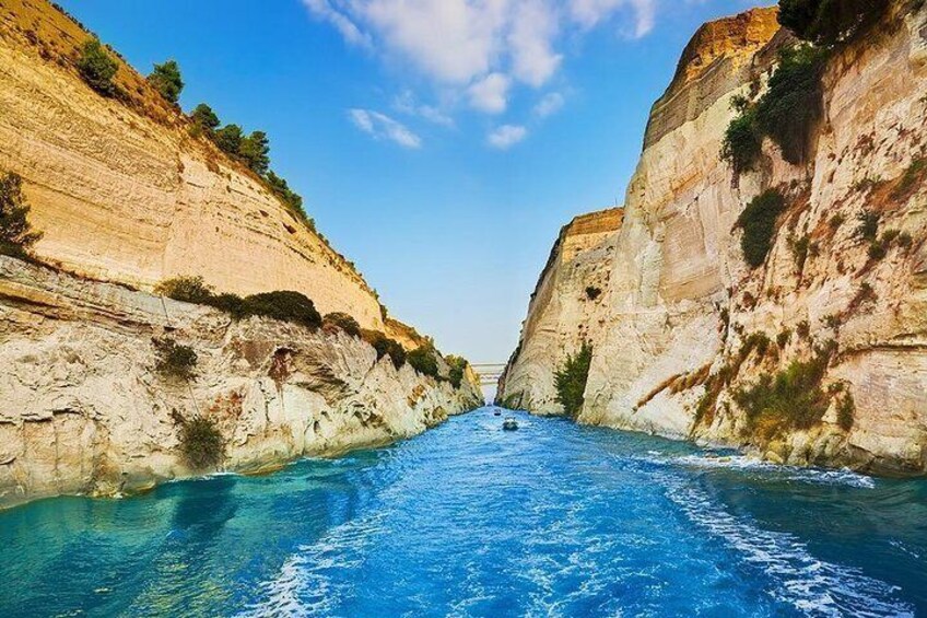 A boat navigating a narrow canyon with steep cliffs on either side. 1