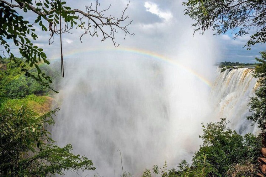 A waterfall with a rainbow. 5