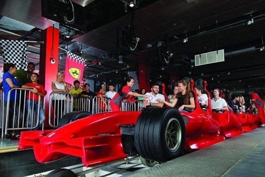 A red race car with passengers inside, surrounded by spectators. 4