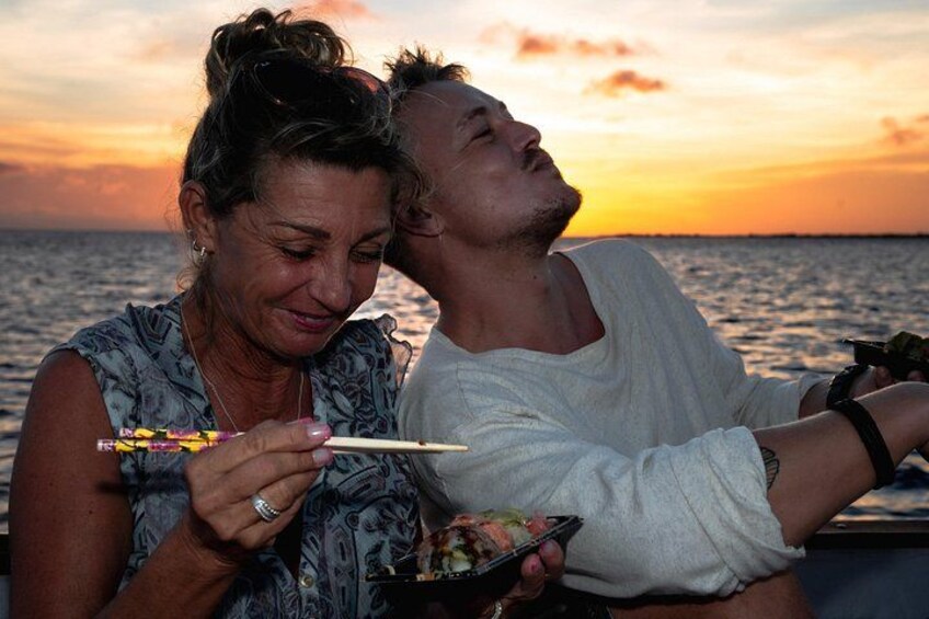 Two people dining by the sea during sunset. 3