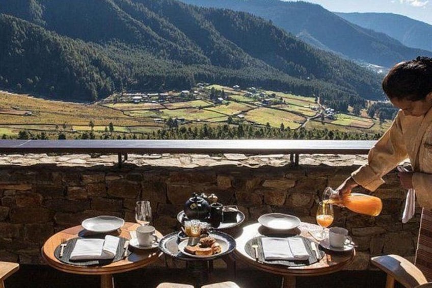 A table set for a meal with a scenic mountain view in the background. 5