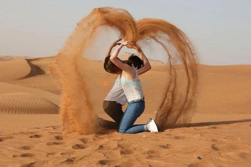 A person in a desert with sand dunes in the background. 3