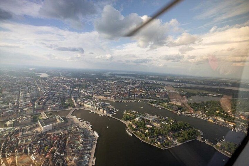 An aerial view of a city with a river, bridges, and a large body of water. 4
