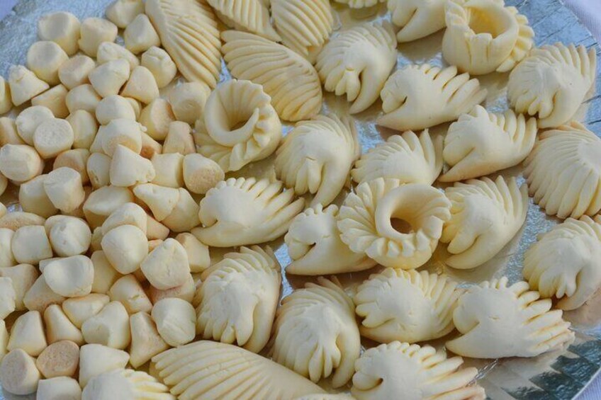 A variety of pasta shapes on a baking sheet. 5