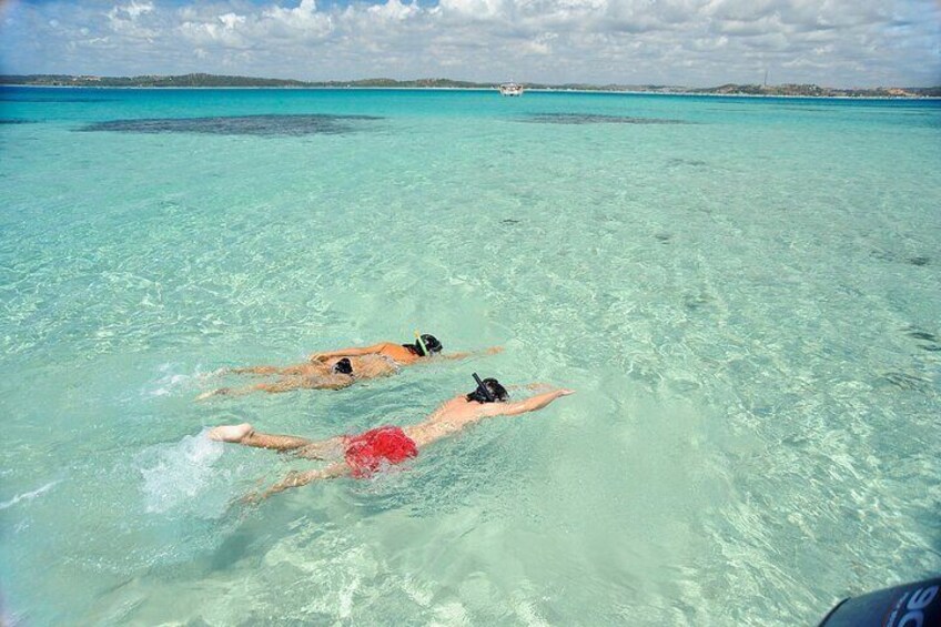 Two people swimming in clear turquoise water. 3