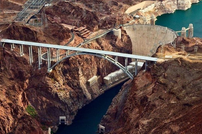 A dam with a bridge crossing over a canyon. 2