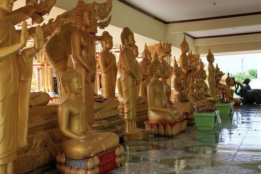 A row of golden Buddha statues in a temple. 2