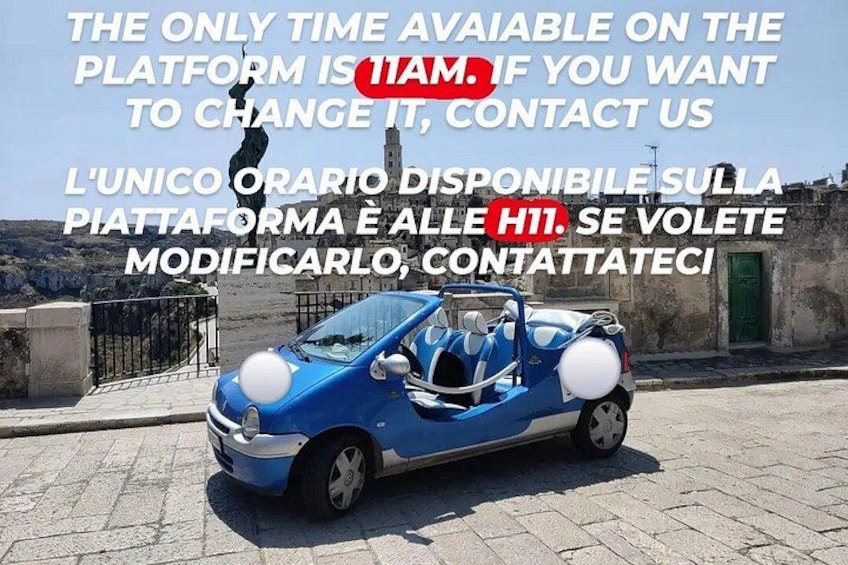 A blue car parked on a cobblestone street with a clear blue sky in the background. 1