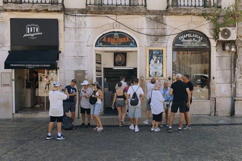 A group of people standing in front of a building with a sign that reads 'CINEMA.' 2
