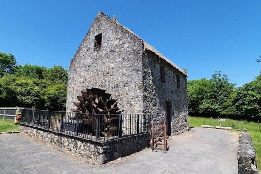 A stone building with a windmill attached to its side. 4