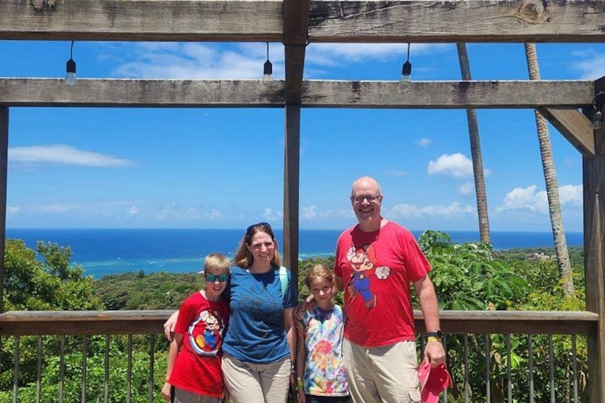 A family on a wooden deck with a scenic ocean view. 3