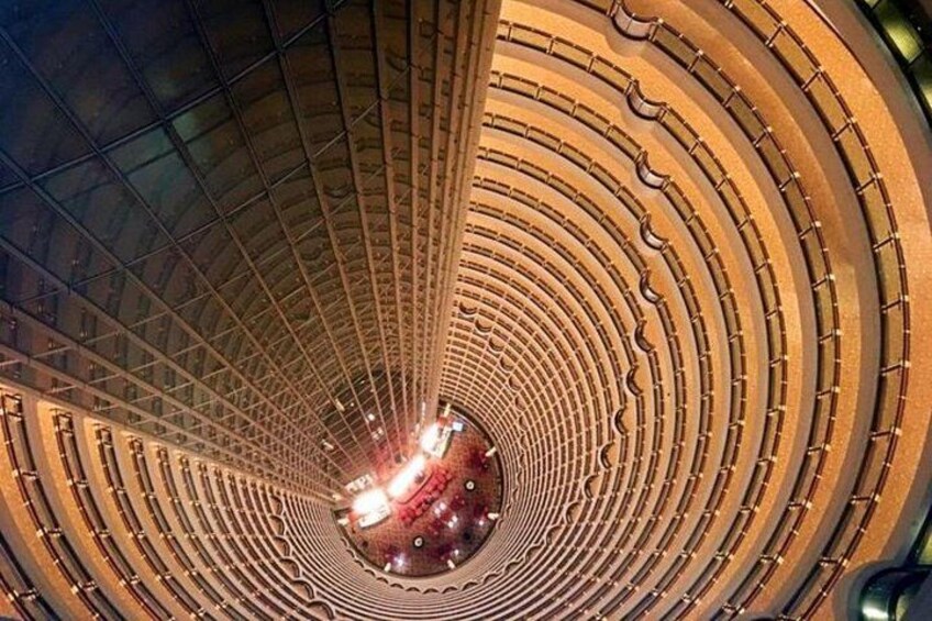 A circular architectural structure with concentric rings and a central light source. 2