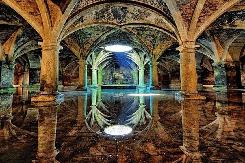 An interior with arched ceilings, columns, and a reflective floor. 2