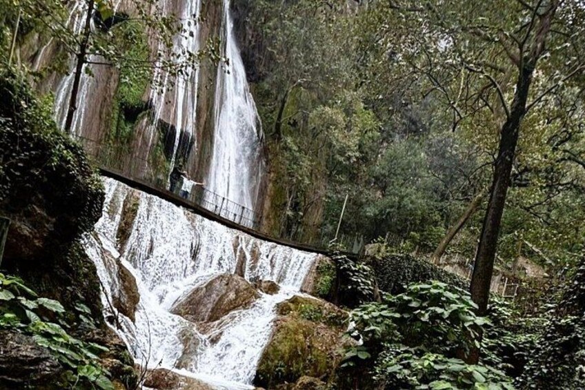 A waterfall with a bridge. 2