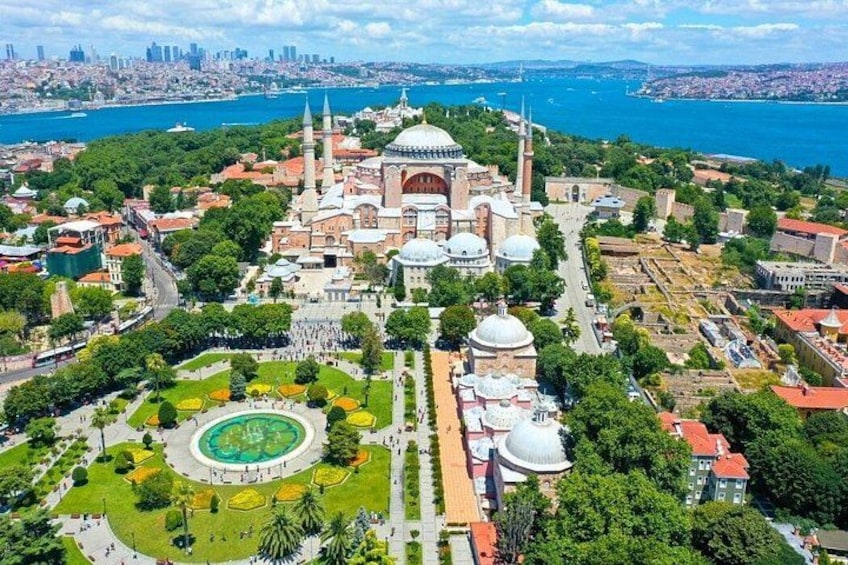 A historic cityscape with a prominent mosque, a large green park, and a waterfront. 5