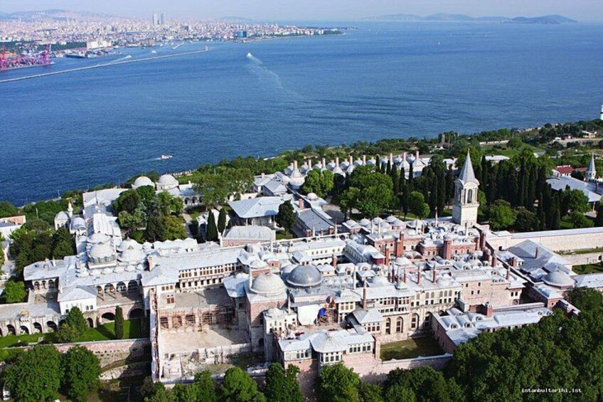 A coastal cityscape with historic architecture, including domed buildings and a prominent tower. 3