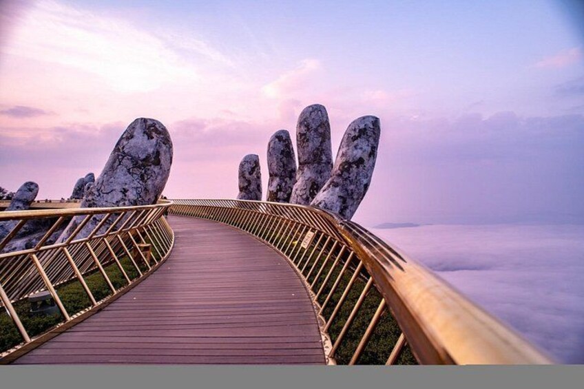 A wooden pathway with a metal railing, leading towards a mountainous landscape. 2