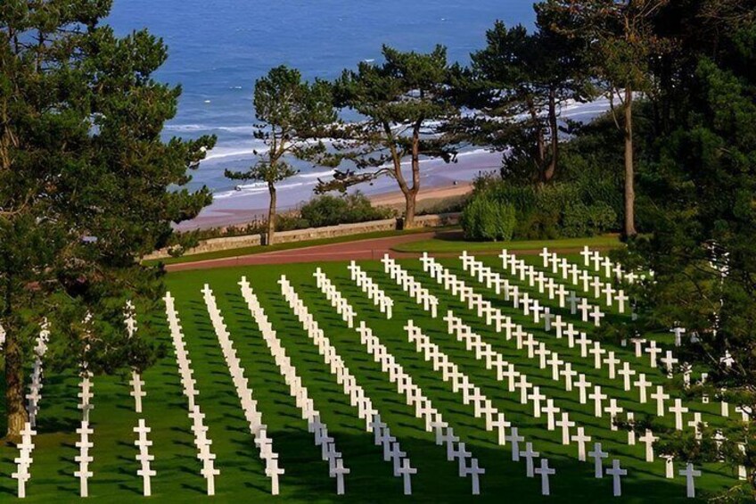 A cemetery with rows of white crosses. 1