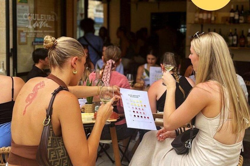 Two women sitting at a table in a restaurant, one holding a menu. 4
