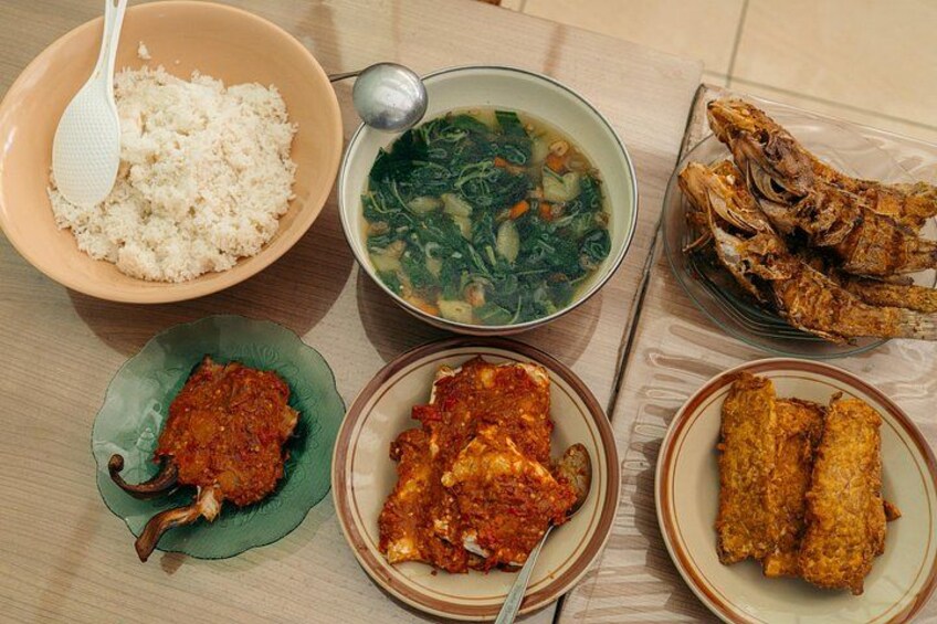 A meal with rice, soup, fried fish, and various side dishes. 3