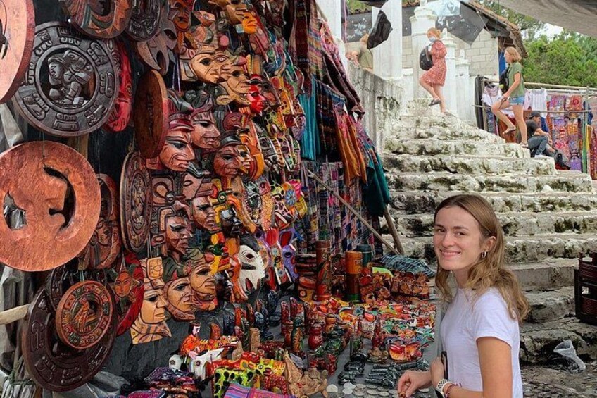 A market stall with various wooden masks and cultural artifacts. 5