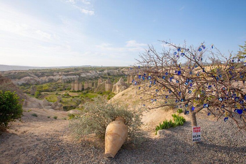 A barren landscape with a tree marked 'WISH TREE AGACIC' and a large vase. 3