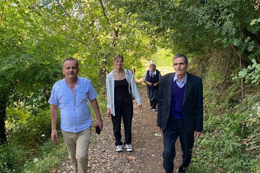 A group of people walking on a forest path. 3
