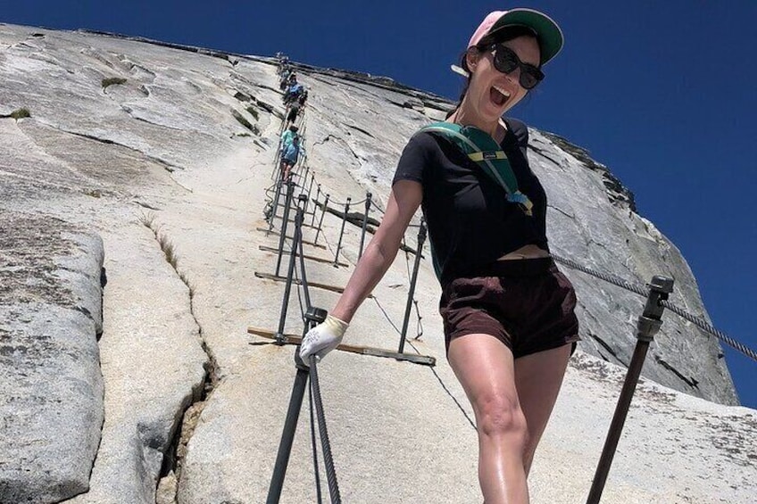 A person climbing a rock face with climbing gear and ropes. 1
