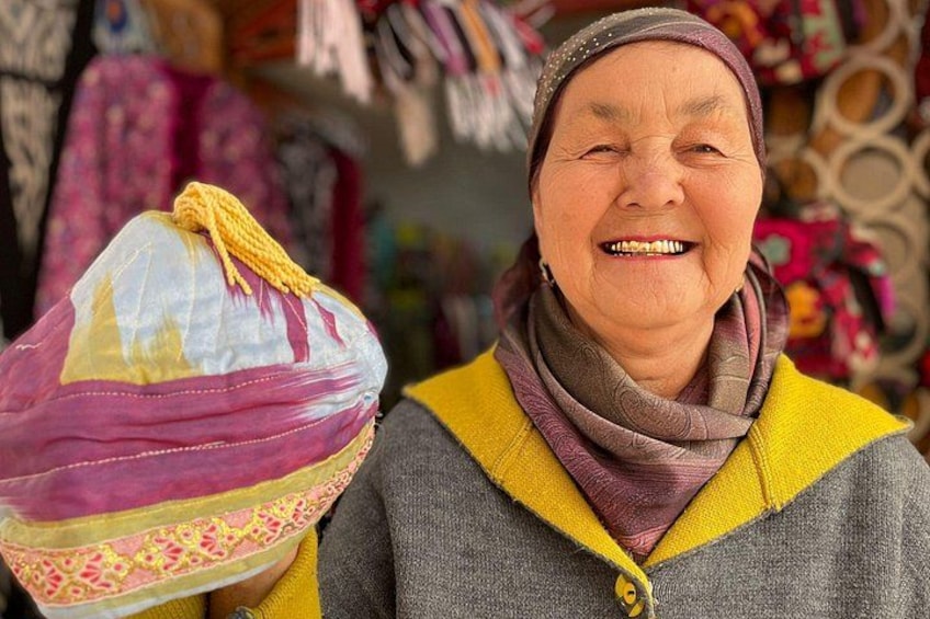 A person holding a colorful bag with a patterned design. 1