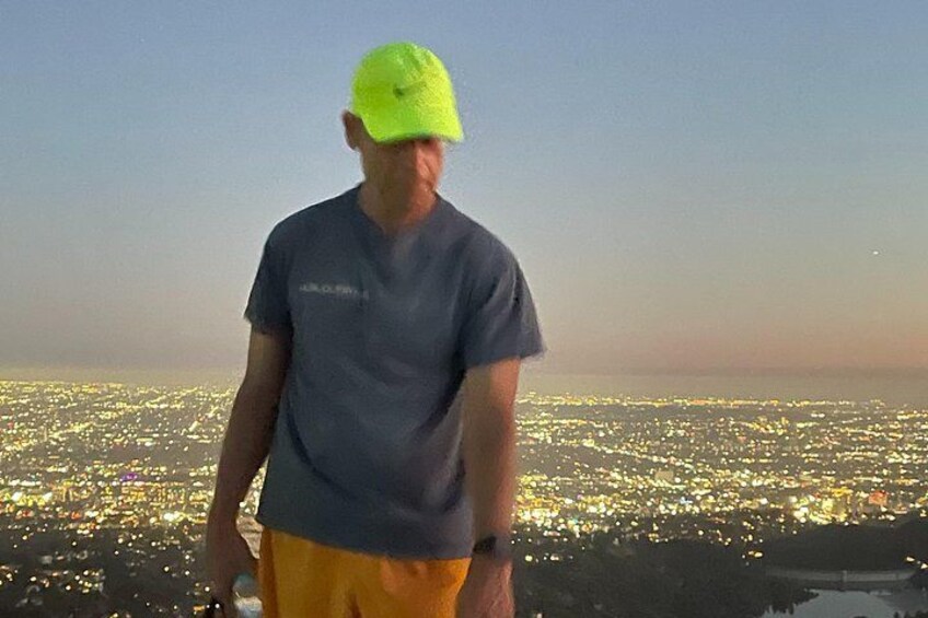 A person standing with a cityscape in the background. 4