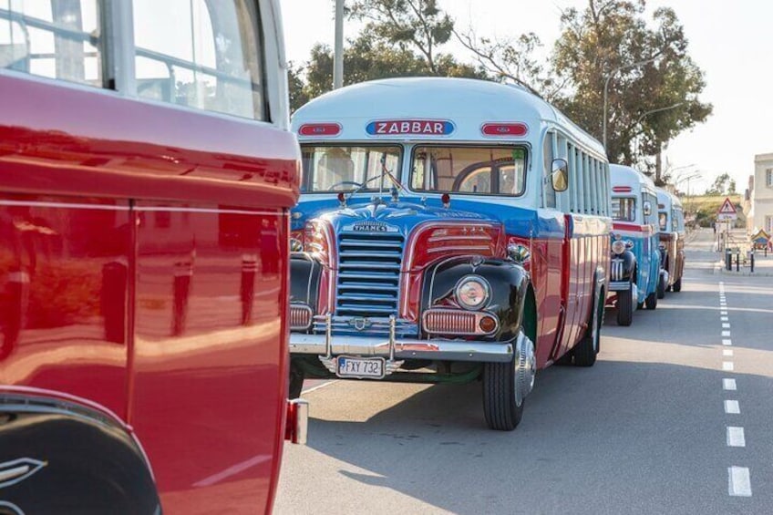 Vintage buses parked on a street. 3