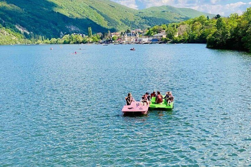 A lake with boats and a mountainous landscape in the background. 3