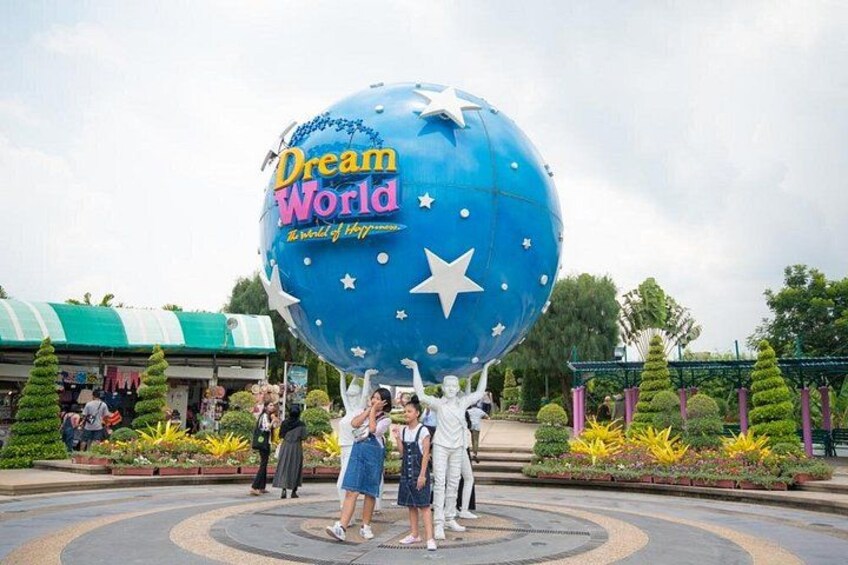 Tourist take photo The large Dream World logo globe.Dream World is one of Thailand's famous theme parks in Pathumtanee ,Thailand 1