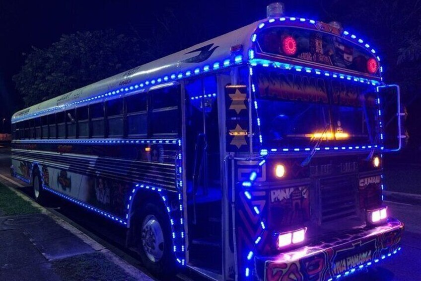 A bus with blue LED lights and graffiti on the side. 5