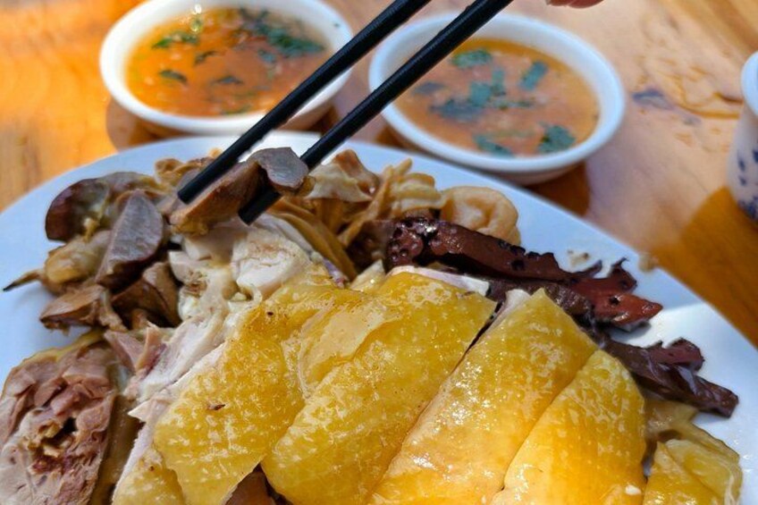 A plate of food with various meats and a bowl of soup. 4