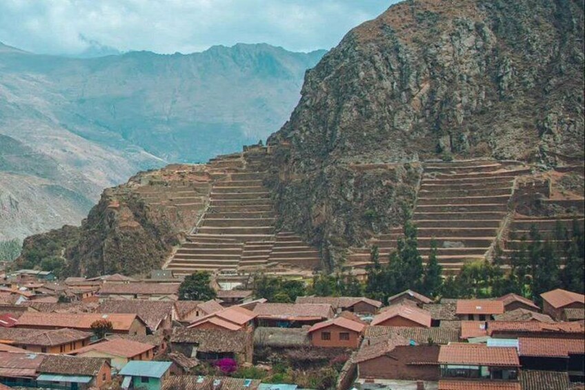 Terraced agricultural fields, traditional houses, and a mountainous backdrop. 5